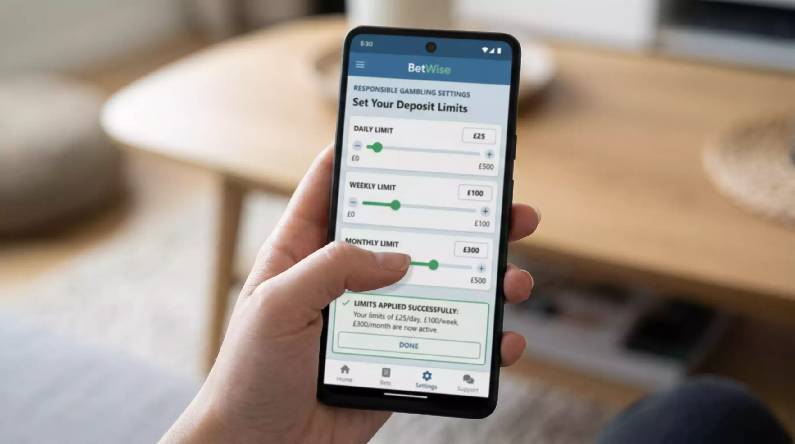 Smartphone displaying responsible gambling settings with deposit limit controls